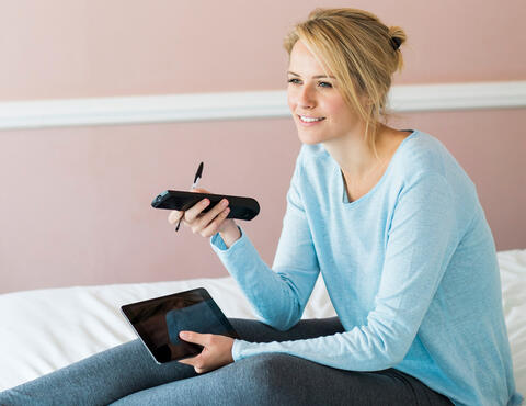 Woman using TV remote